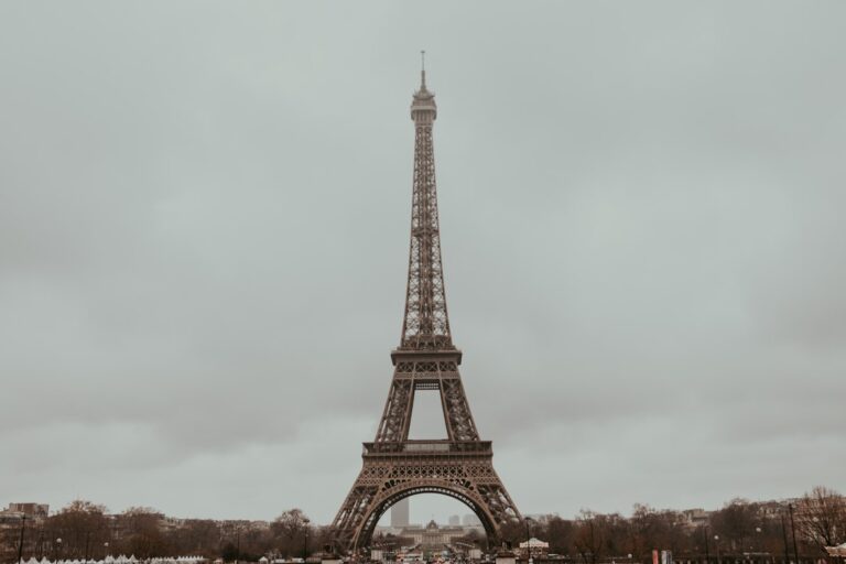 A view of Eiffel tower in Paris in fog and clouds.