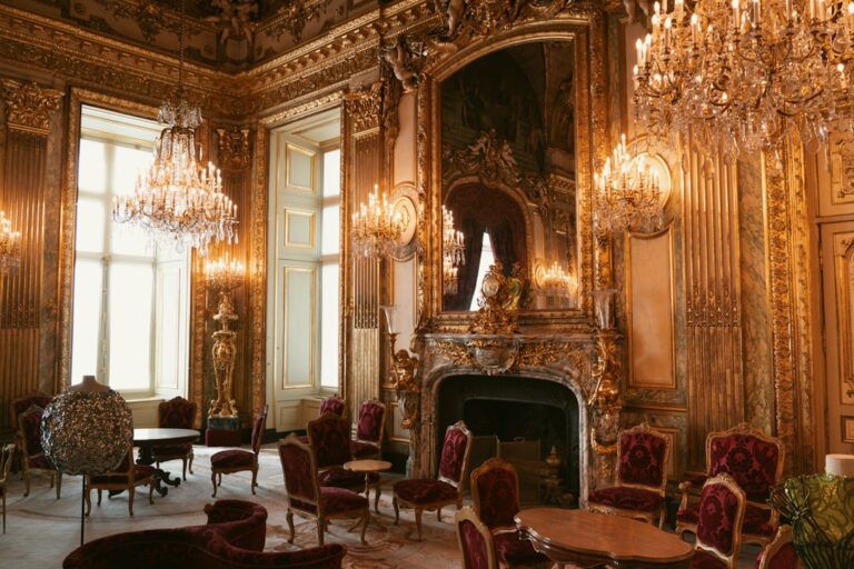 A luxurious, gilded room with chandeliers.